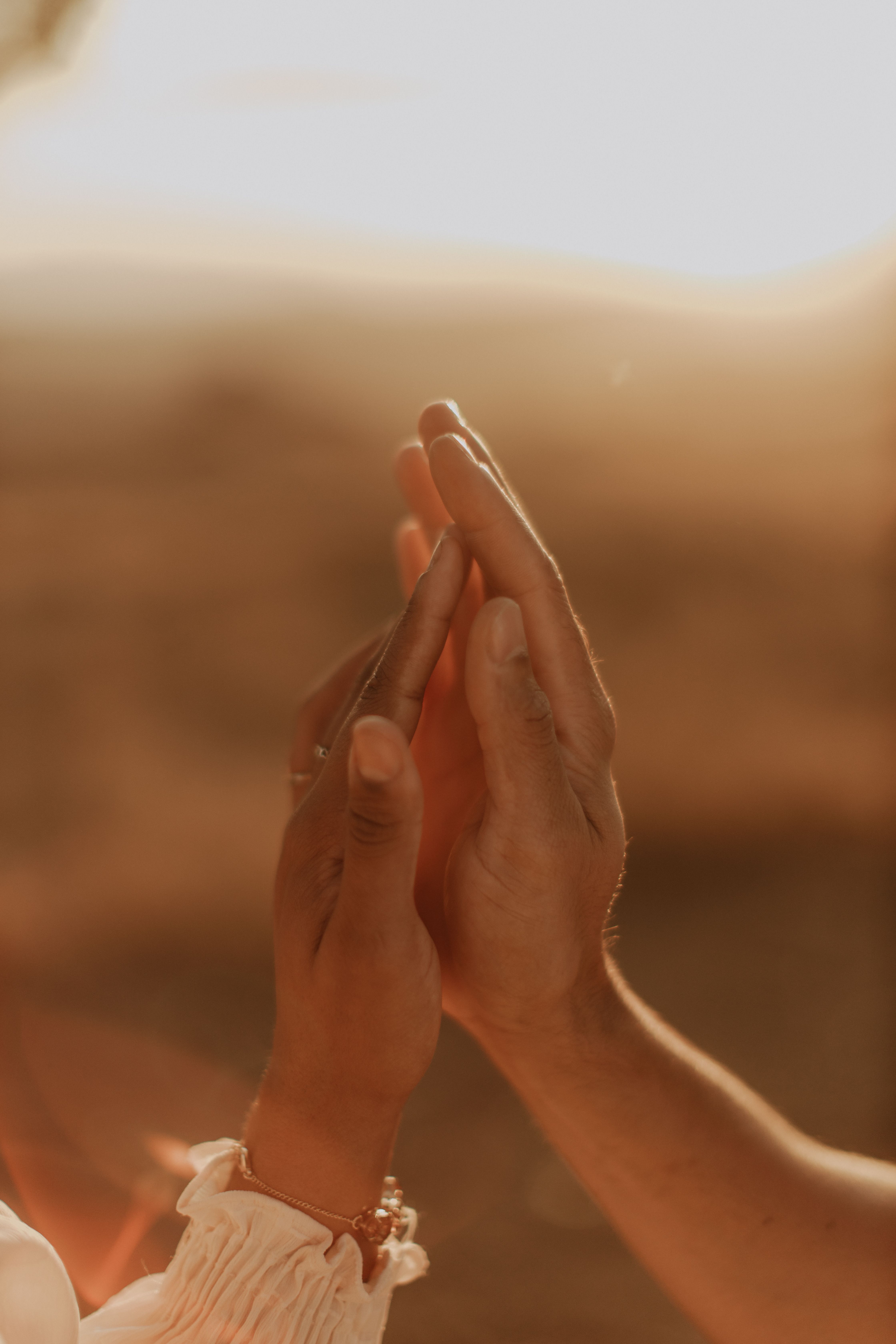 Hands Touching Gently in Warm Sunset Light · Free Stock Photo