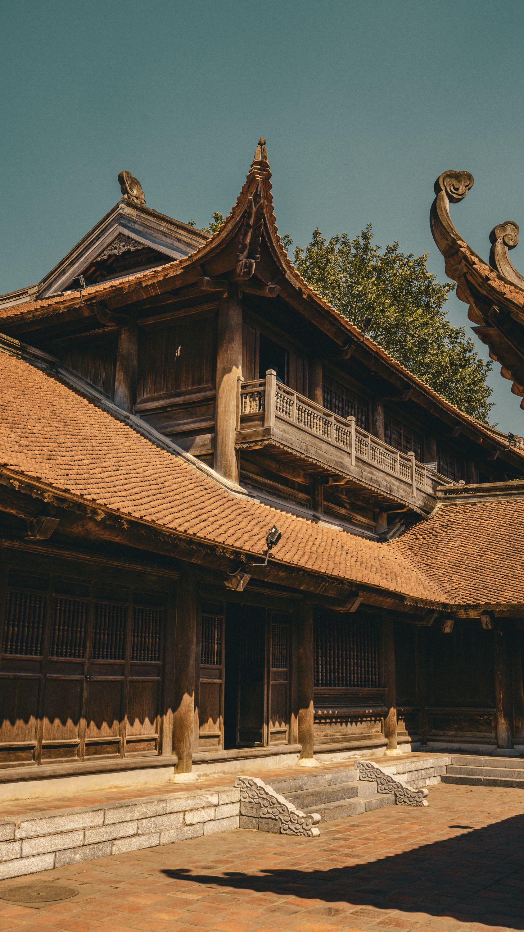 Explore the intricate details of a historic Vietnamese temple featuring traditional architecture and ornate woodwork.