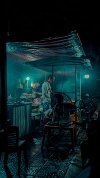 A vibrant street food stall at night in Hanoi, Vietnam showcasing local culture.