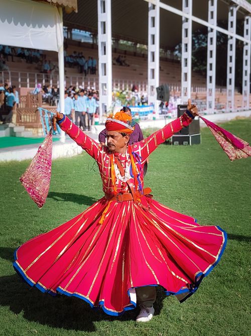 Free Traditional Indian dancer in colorful attire spinning gracefully outdoors. Stock Photo