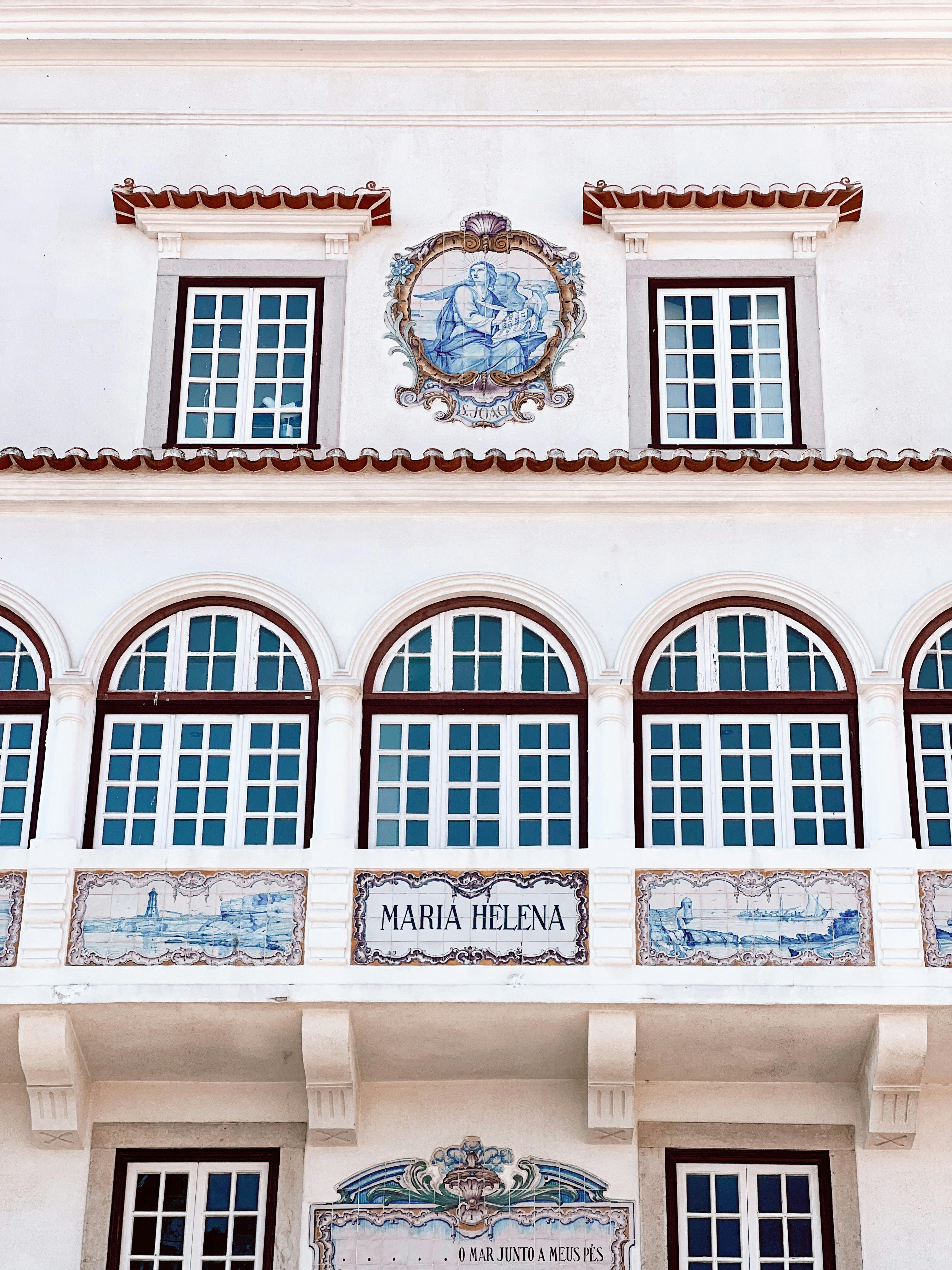 Elegant facade with classic architecture and detailed tile designs, featuring arched windows.