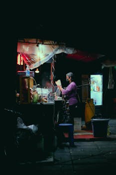 A vibrant night scene of a street food vendor in Cholula, Mexico.