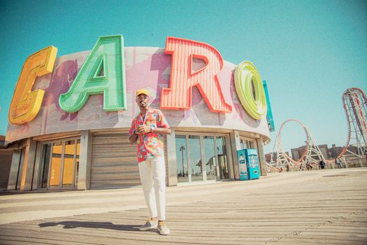 Man Standing Beside Caro Signage