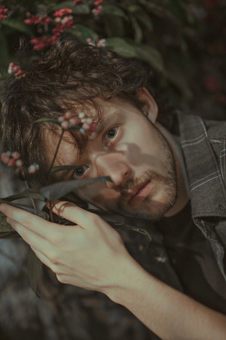 Man Holding Flowering Plant