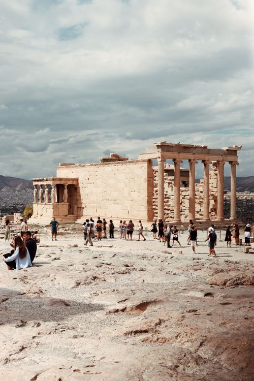 Free Tourists explore the ancient Acropolis in Athens, showcasing its historical architecture. Stock Photo