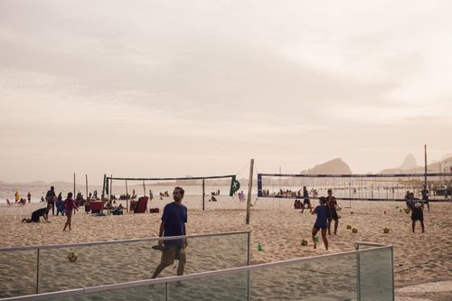 Free People playing beach volleyball at Ipanema Beach, Rio de Janeiro, enjoying a sunny day. Stock Photo