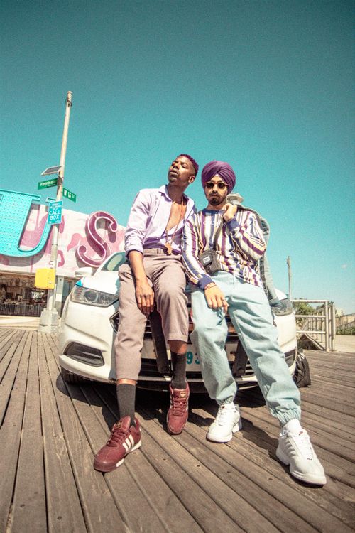 Free Two fashionable young men posing outdoors on a sunny day in New York. Vibrant style and casual demeanor. Stock Photo