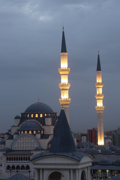 Free Beautifully lit mosque minarets at twilight, showcasing Islamic architecture. Stock Photo