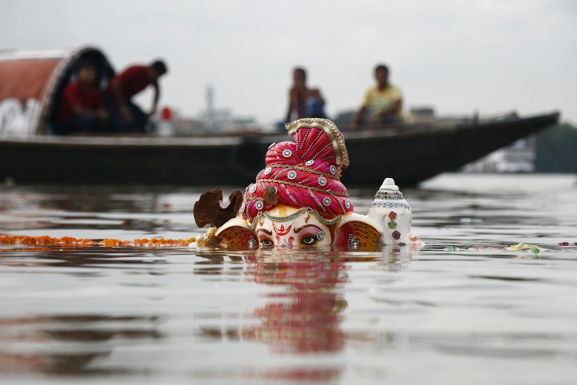 Lord Ganesha Statuette Submerged on Body of Water