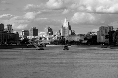 Free A captivating black and white view of central Moscow across the river, showcasing urban architecture. Stock Photo