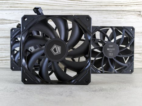 Close-up of three high-performance computer cooling fans arranged in a stack on a neutral background.