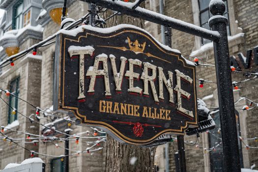 Taverne sign in snowy winter setting on Grande Allée, Quebec City.