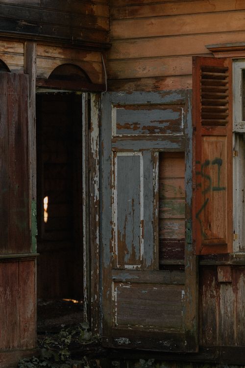 Free A rustic, weathered door on an old wooden house, showcasing natural decay. Stock Photo