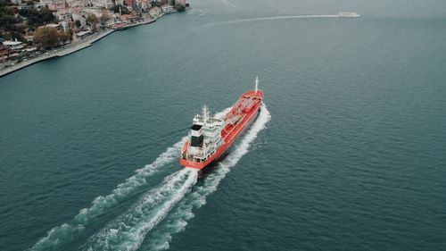 Free Aerial shot of a red cargo ship navigating the Bosphorus Strait near Istanbul, Turkey. Stock Photo