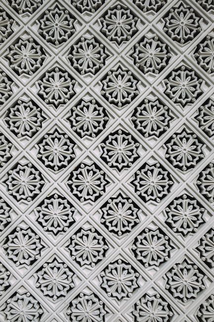 Intricate geometric design from Malaysian architecture showcasing detailed craftsmanship and symmetry.