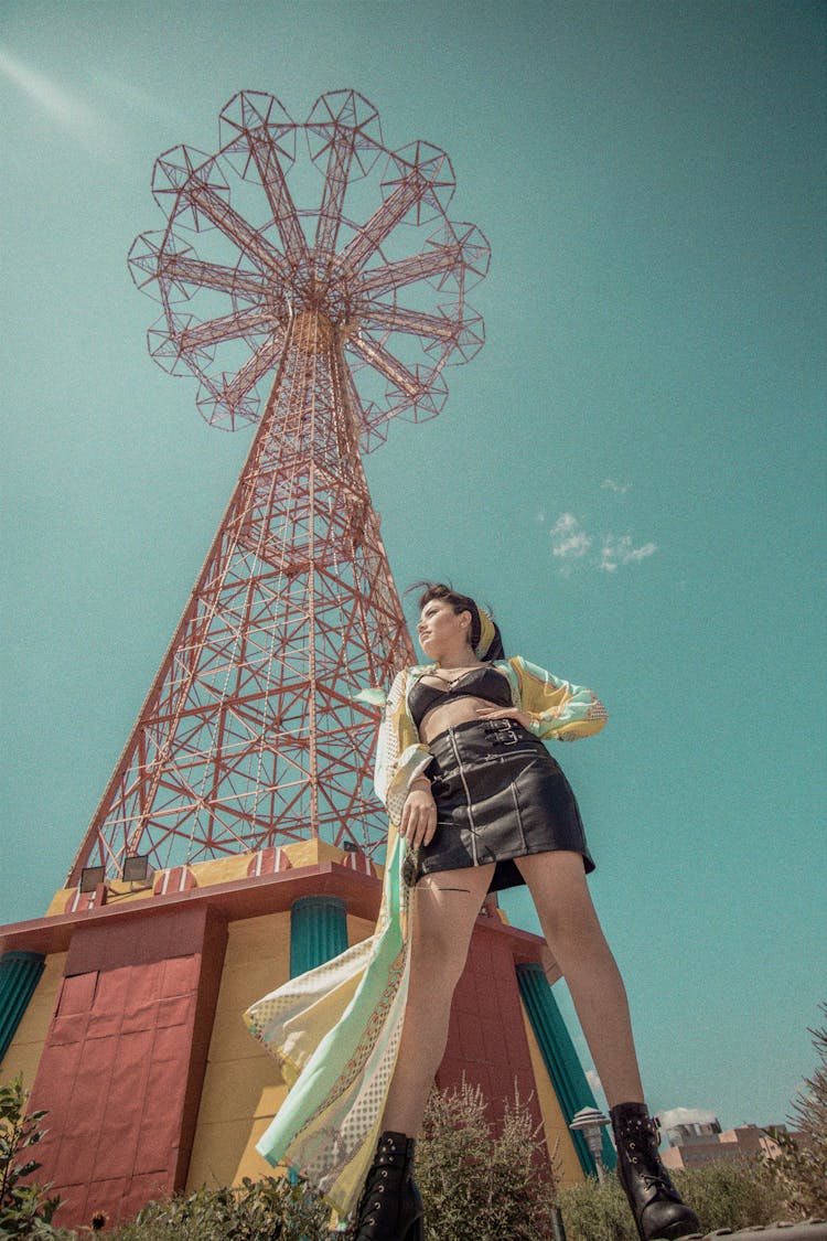 Low Angle Photography Of Woman Standing Under Tower