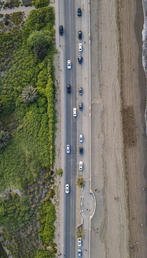 Free Stunning aerial view of a beachside road in Muscat, Oman, highlighting the natural and urban landscapes. Stock Photo