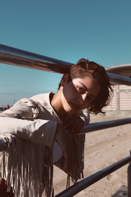 Free Woman Leaning On A Gray Metal Railing Stock Photo