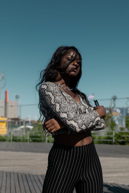 Fashionable woman in trendy outfit poses confidently outdoors in NYC.