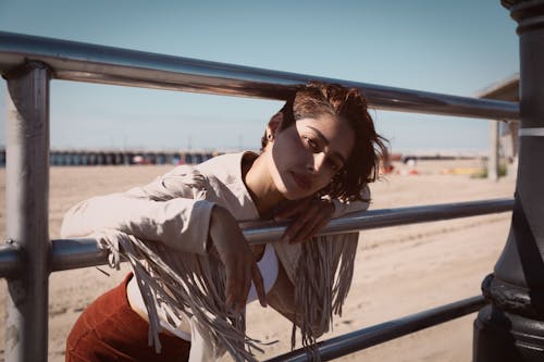 Free Selective Focus Photography of Woman Leaning on Rail Stock Photo