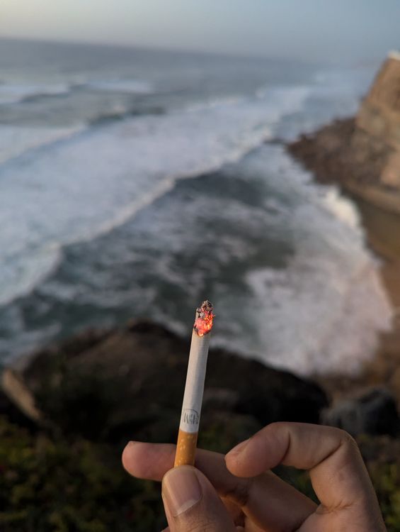 Smoking on the Edge: Ocean View in Colares · Free Stock Photo