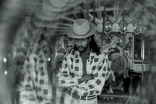 Gray scale Photography of Man Wearing a Hat and Plaid  Shirt