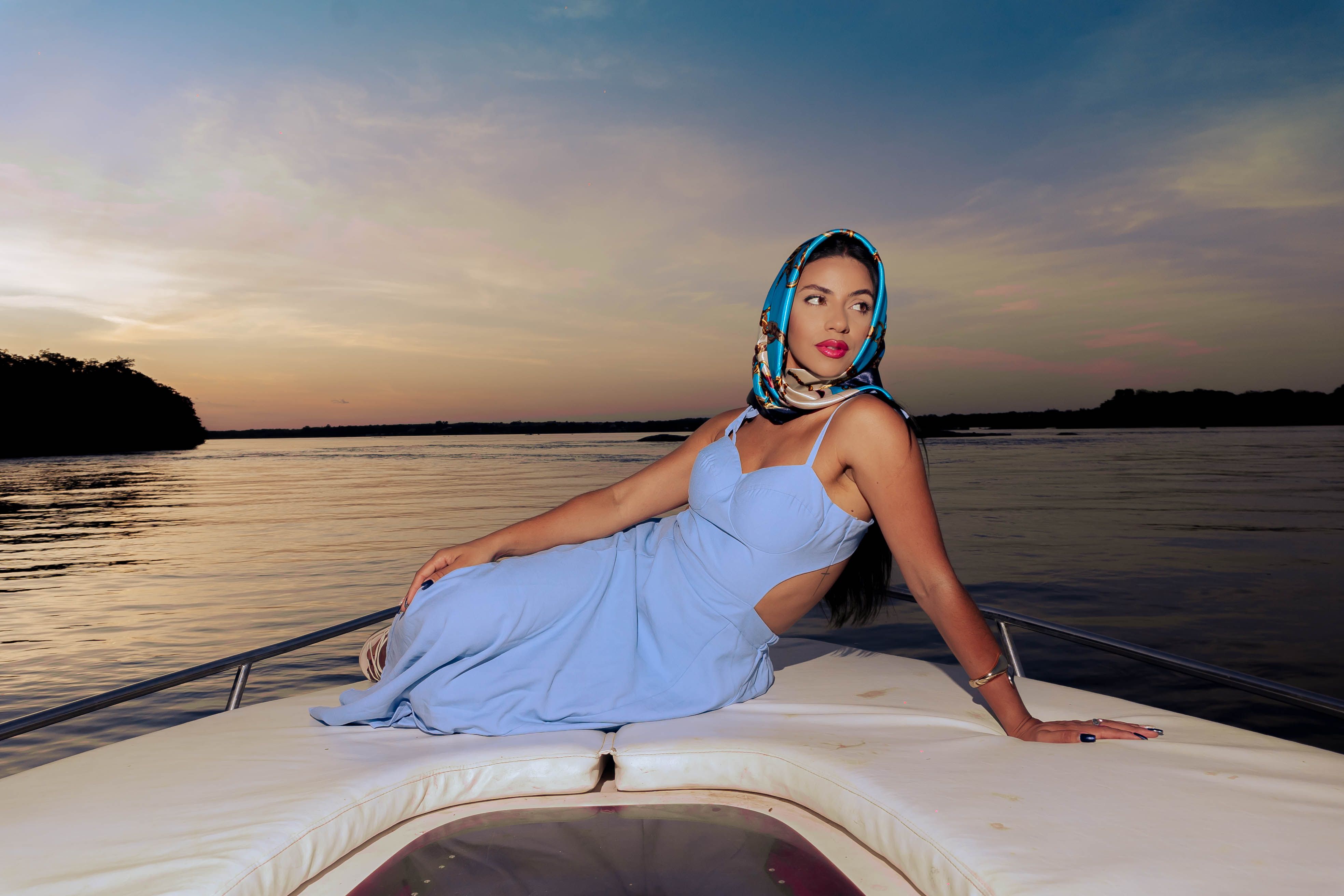 Elegant Woman in Blue Dress Relaxing on a Yacht at Sunset · Free Stock ...