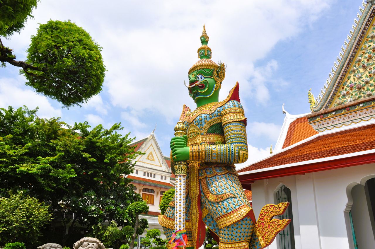 colorful demon guardian statue at wat arun in bangkok thailand