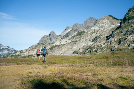Two hikers on a scenic trail in Darrington, Washington, with mountain views.