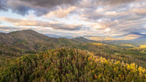 Free Scenic aerial view of Appalachian Mountains with autumn foliage under dramatic clouds. Stock Photo