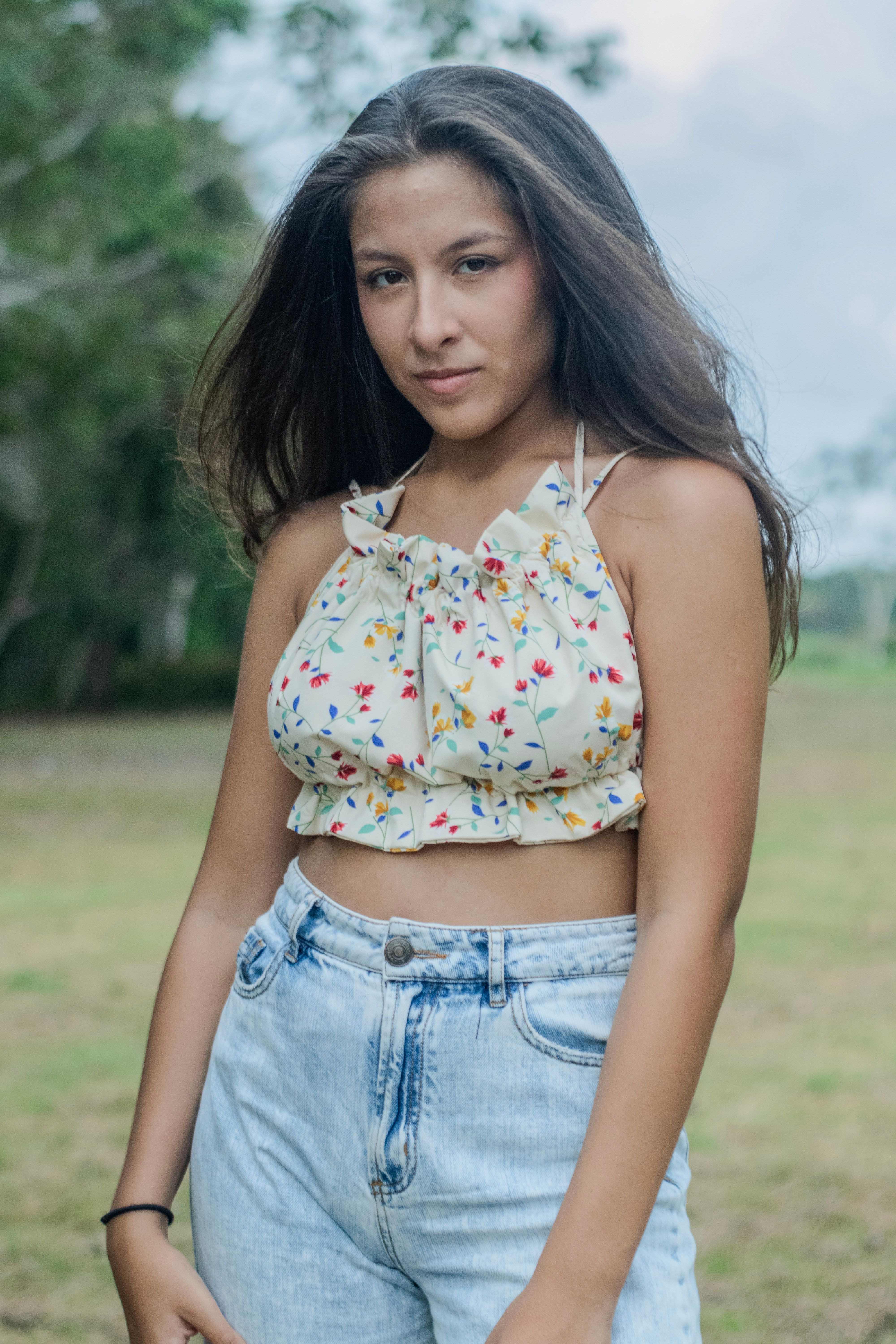 Young Woman in Floral Top Outdoors · Free Stock Photo
