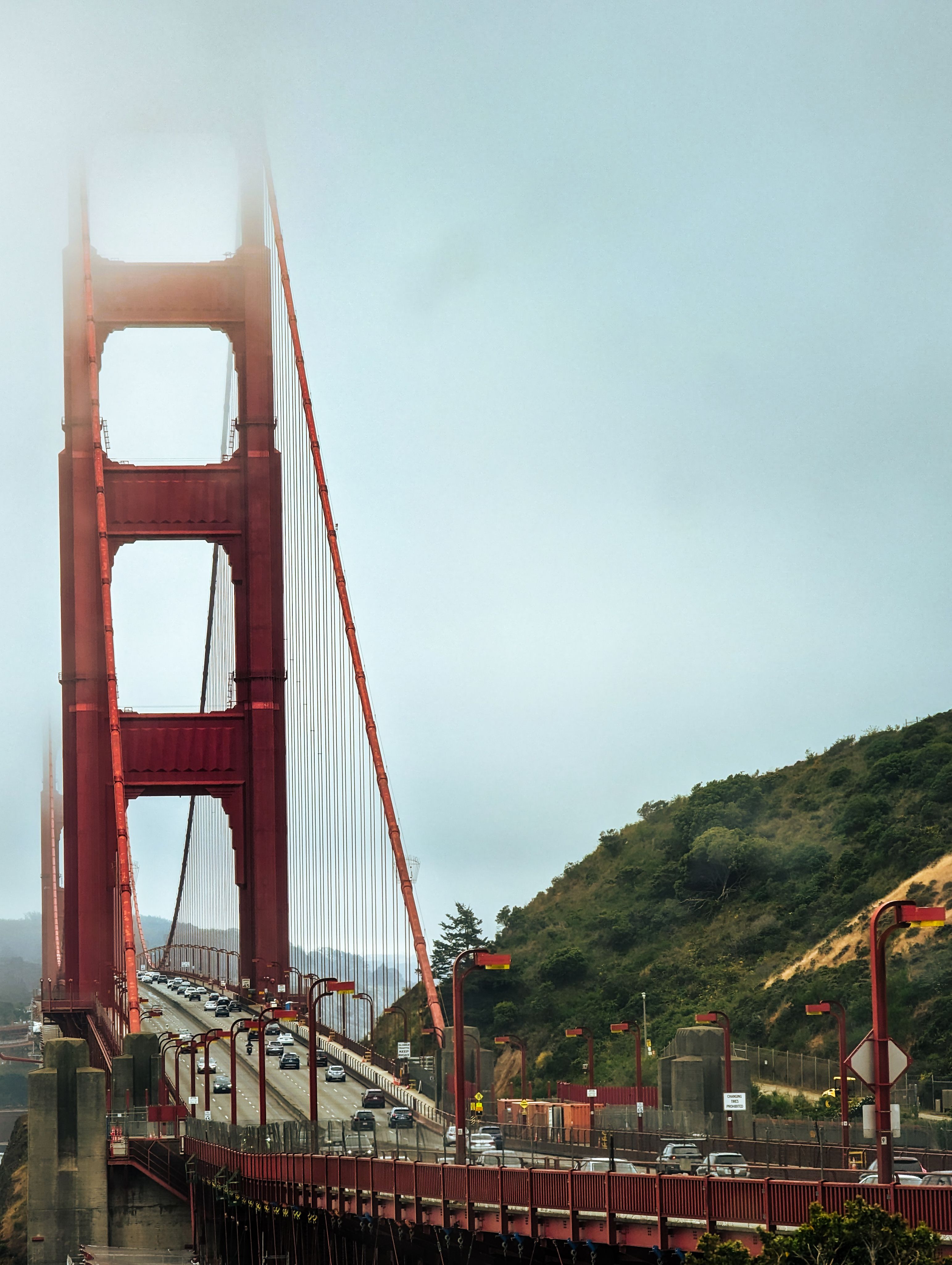 Iconic view of the Golden Gate Bridge emerging through fog in San Francisco, California.