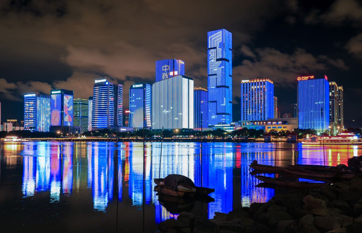 Vibrant City Skyline Reflecting in Water at Night · Free Stock Photo