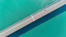 Aerial View of a Bridge Over Turquoise Water