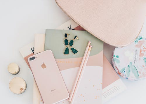 Free Rose Gold Iphone 7 Plus Beside Pencils on Book Stock Photo