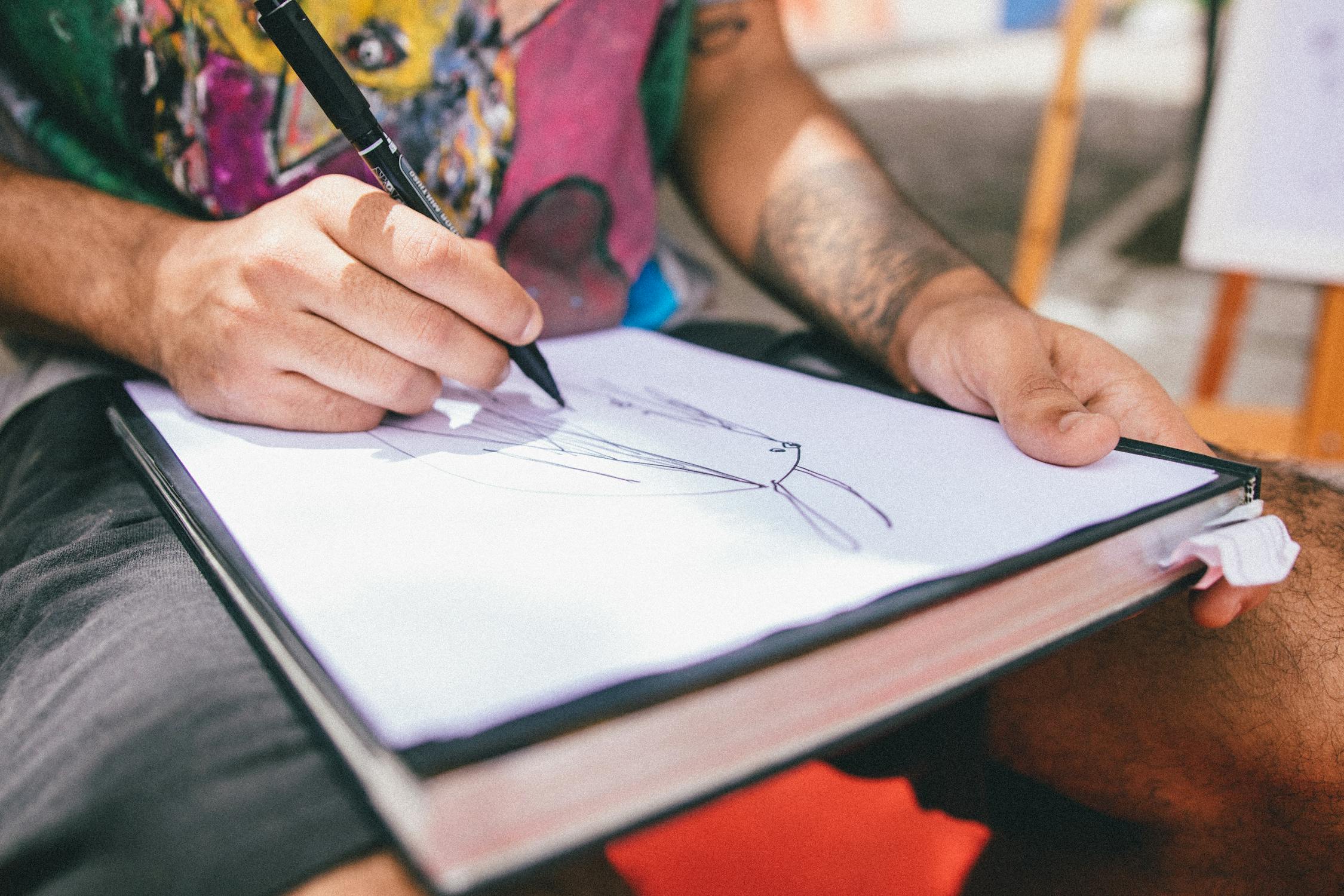 Person Drawing on Paper · Free Stock Photo