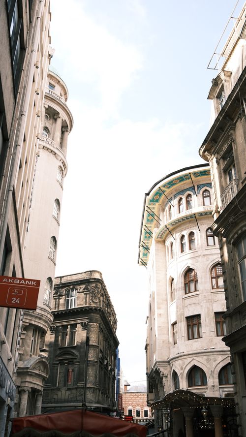 Free High-angle view of a narrow European street flanked by historic buildings and clear sky. Stock Photo