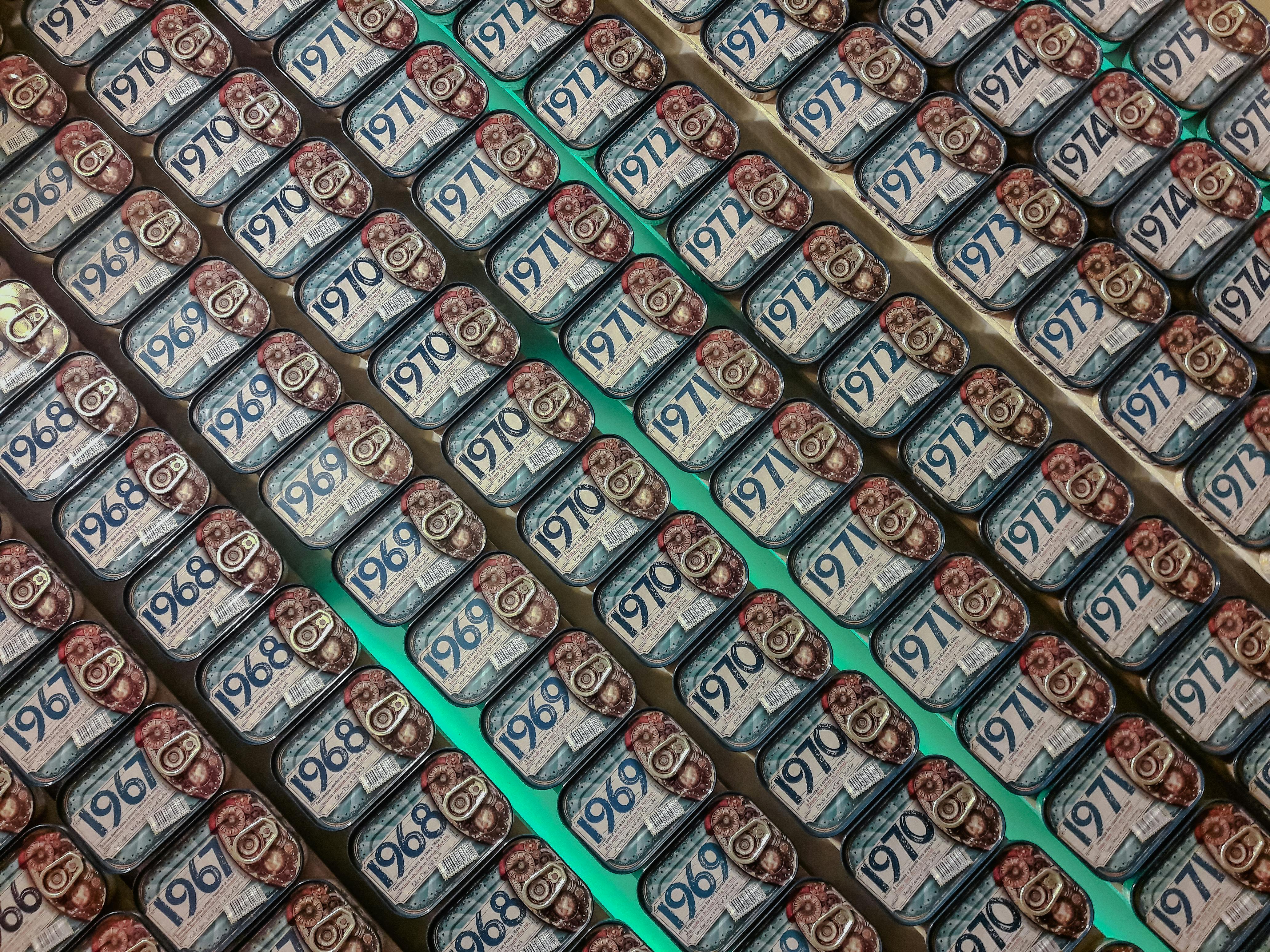 Free Rows of vintage sardine cans on display, showcasing various years in a Porto shop. Stock Photo