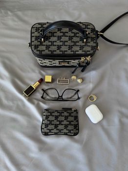 Elegant flat lay showcasing a handbag, lipstick, jewelry, glasses, and beauty essentials.