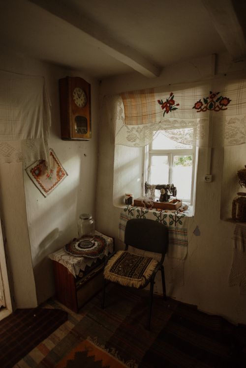 Free Sunlit interior of a cozy, traditional home with floral decor and rustic charm. Stock Photo