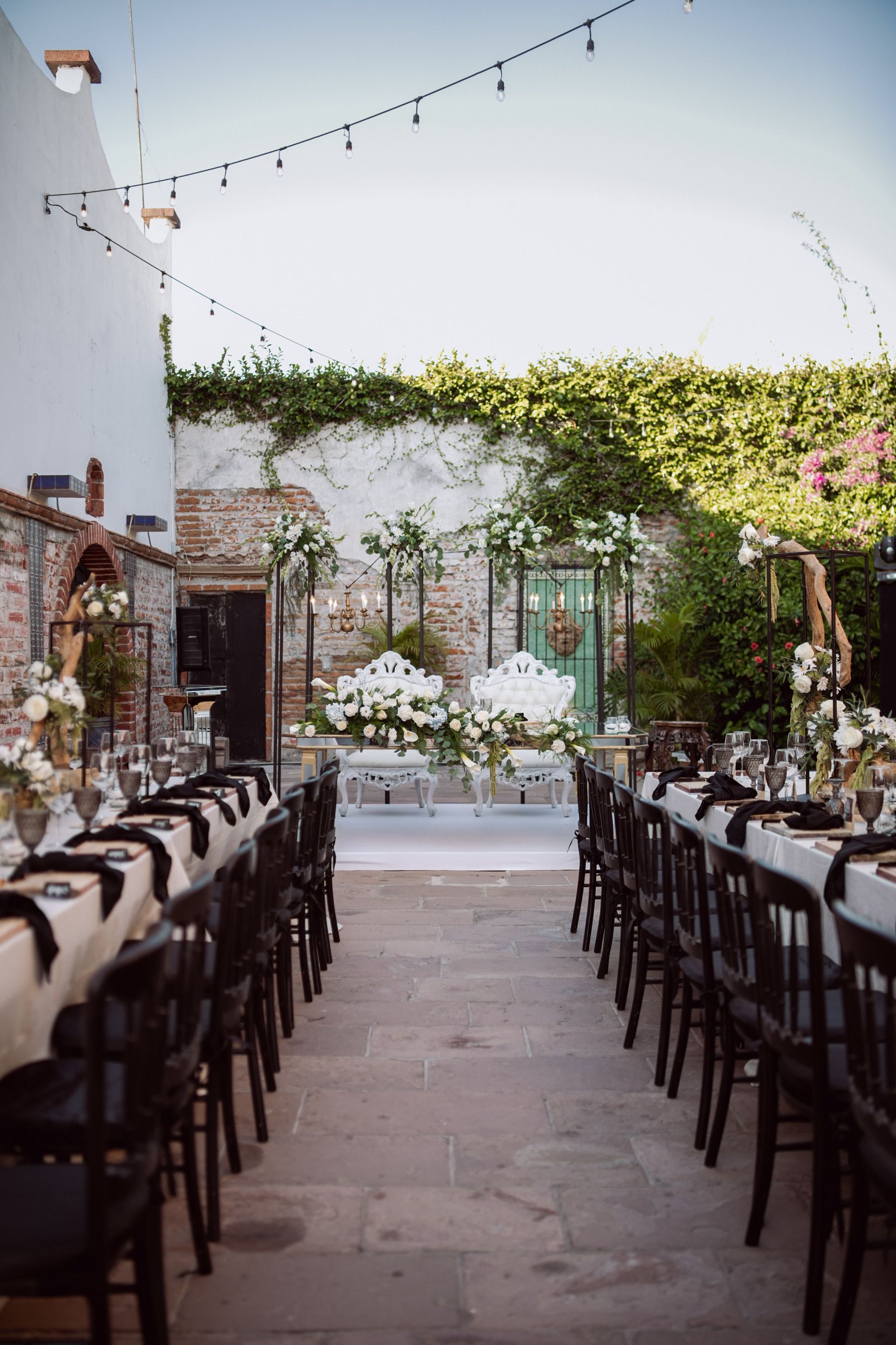 An elegant outdoor wedding reception under string lights