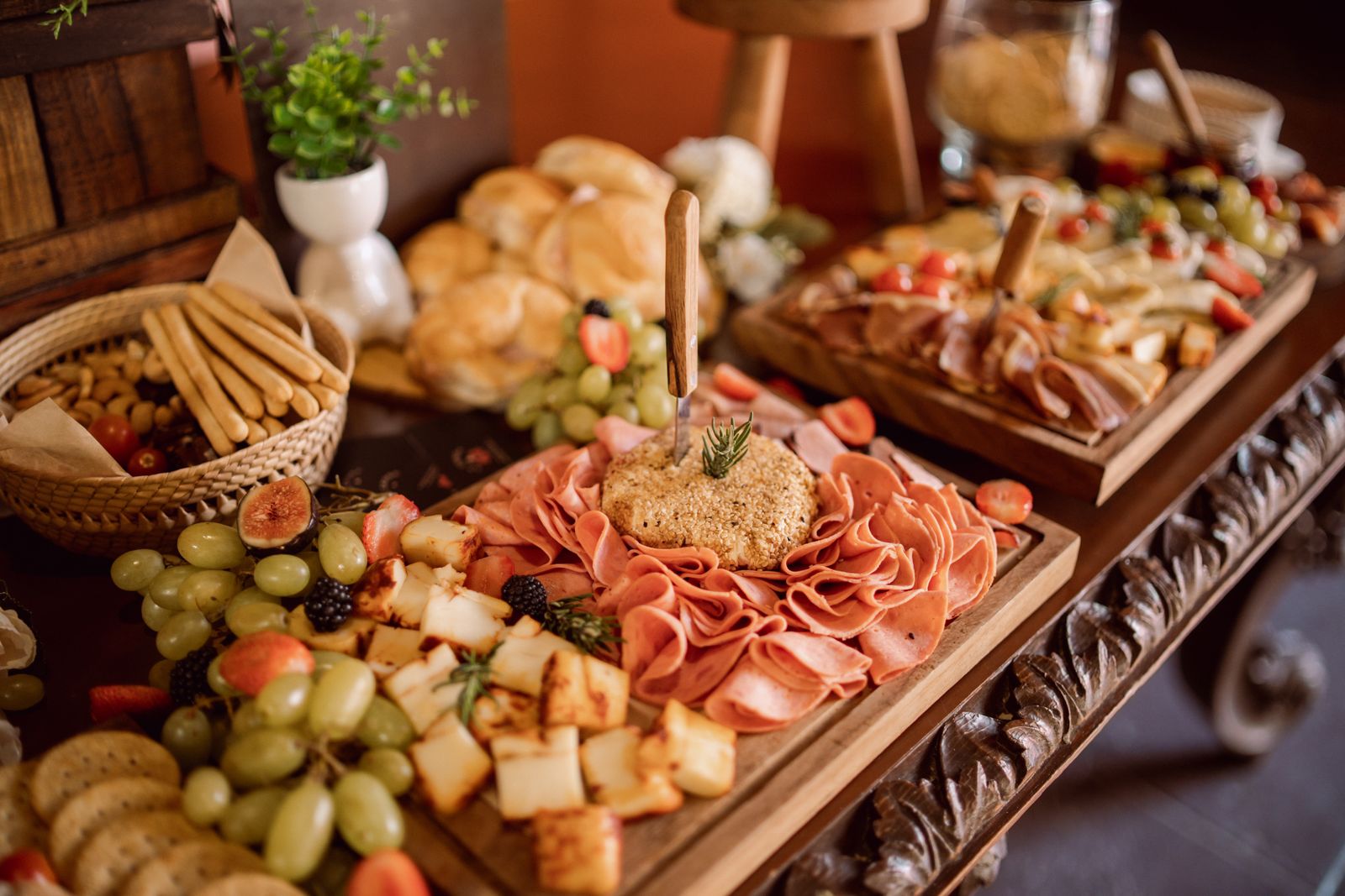 A grazing table with cured meats, cheeses, bread and fruit