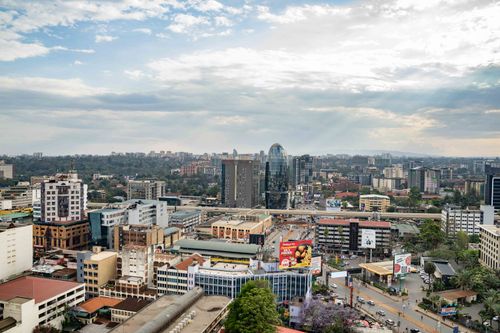Free A vibrant aerial shot of Nairobi's bustling cityscape with modern architecture under a partly cloudy sky. Stock Photo