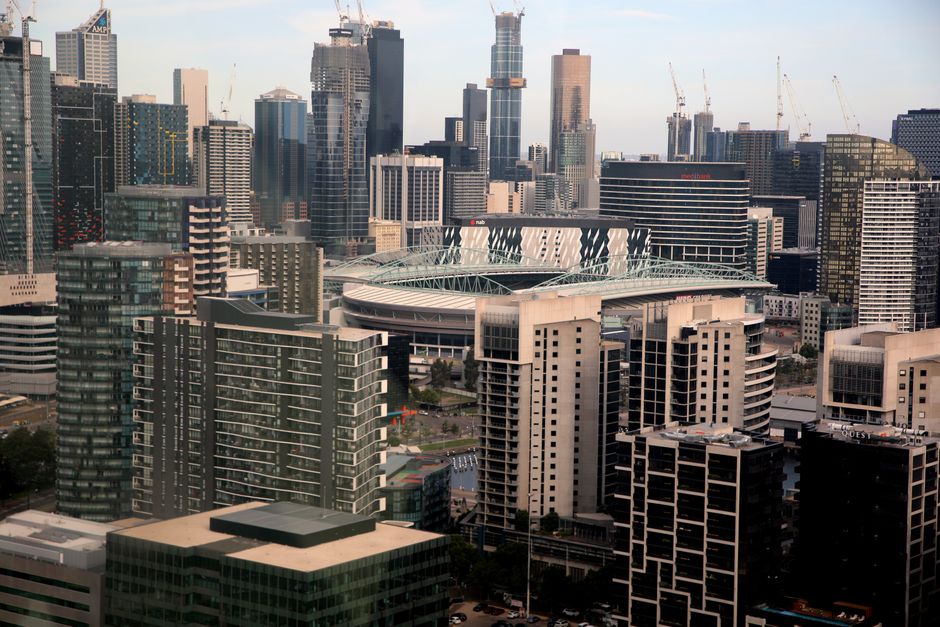 Private Helicopter Scenic Tour of Brisbane - 25min - Aerial view showcasing Docklands, Melbourne skyline with high-rise buildings and iconic architecture.
