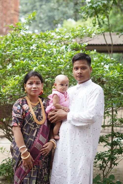 Free A South Asian family depicted in traditional attire, outdoors in Bangladesh. Stock Photo