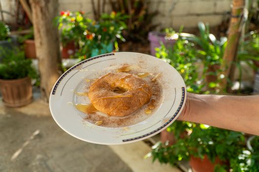 Delicious sweet tiganopsomo topped with honey. Shot in an outdoor setting in Schimatari, Greece.