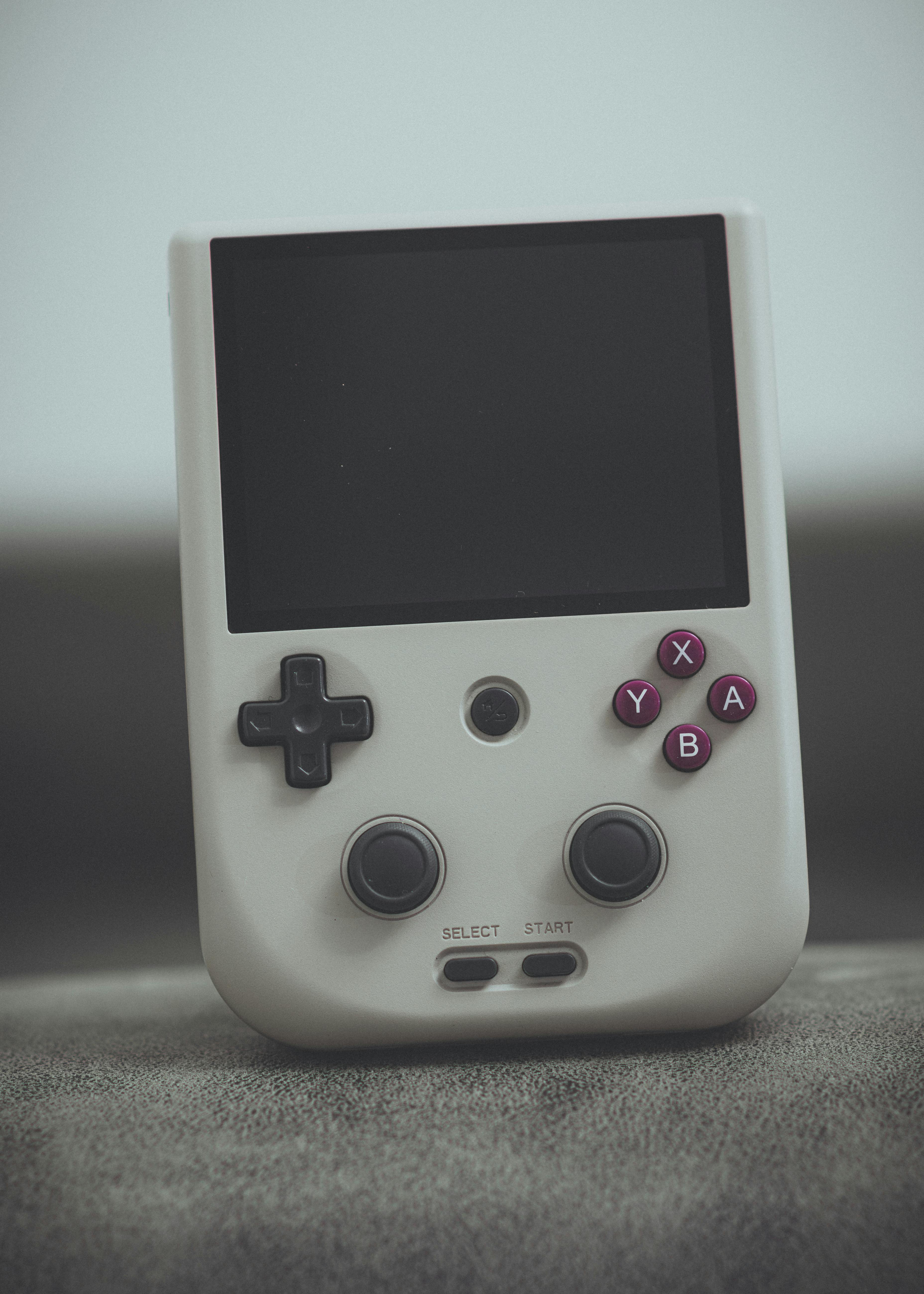 Close-up of a vintage handheld gaming console with classic design and retro buttons.