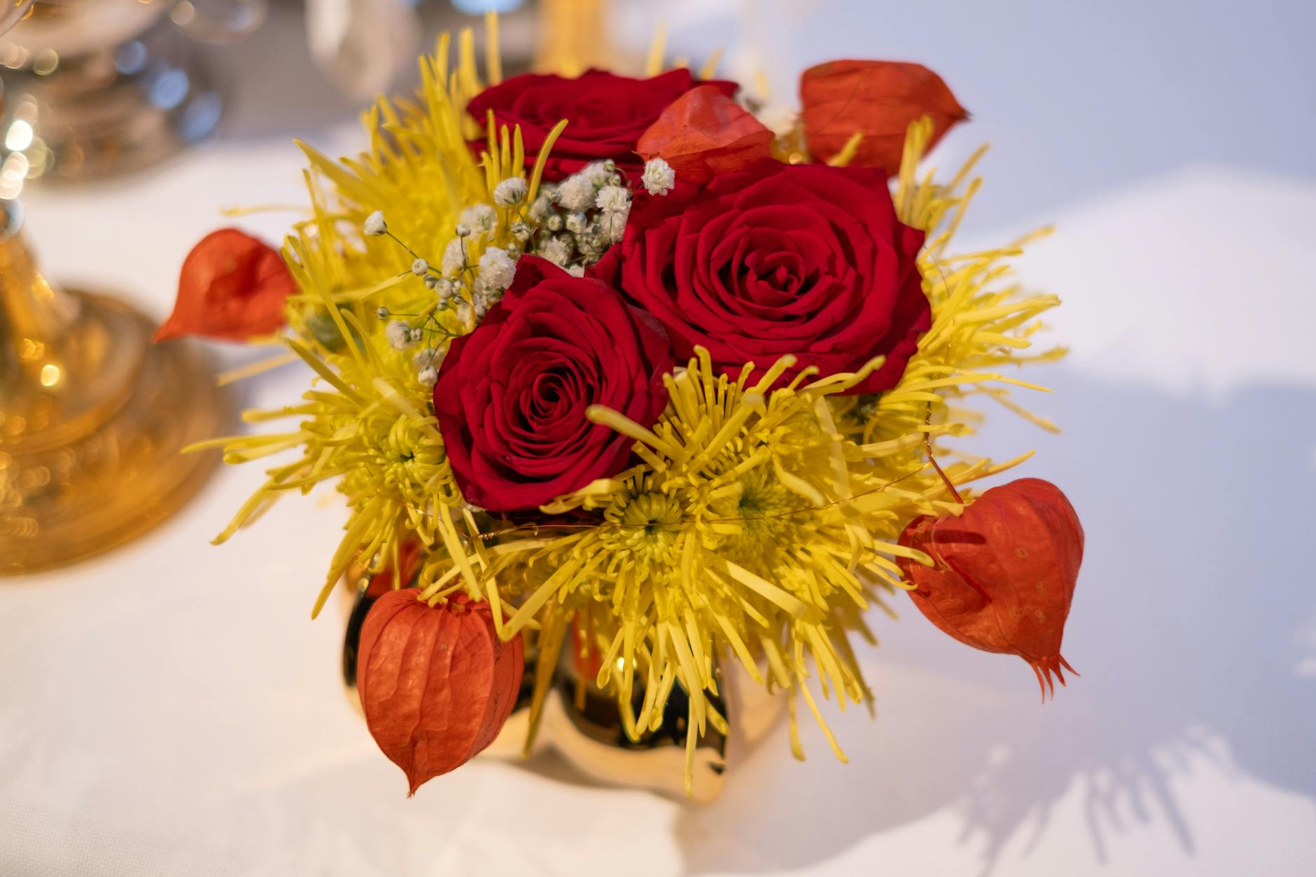 https://www.pexels.com/photo/elegant-red-and-yellow-floral-centerpiece-arrangement-28978613/