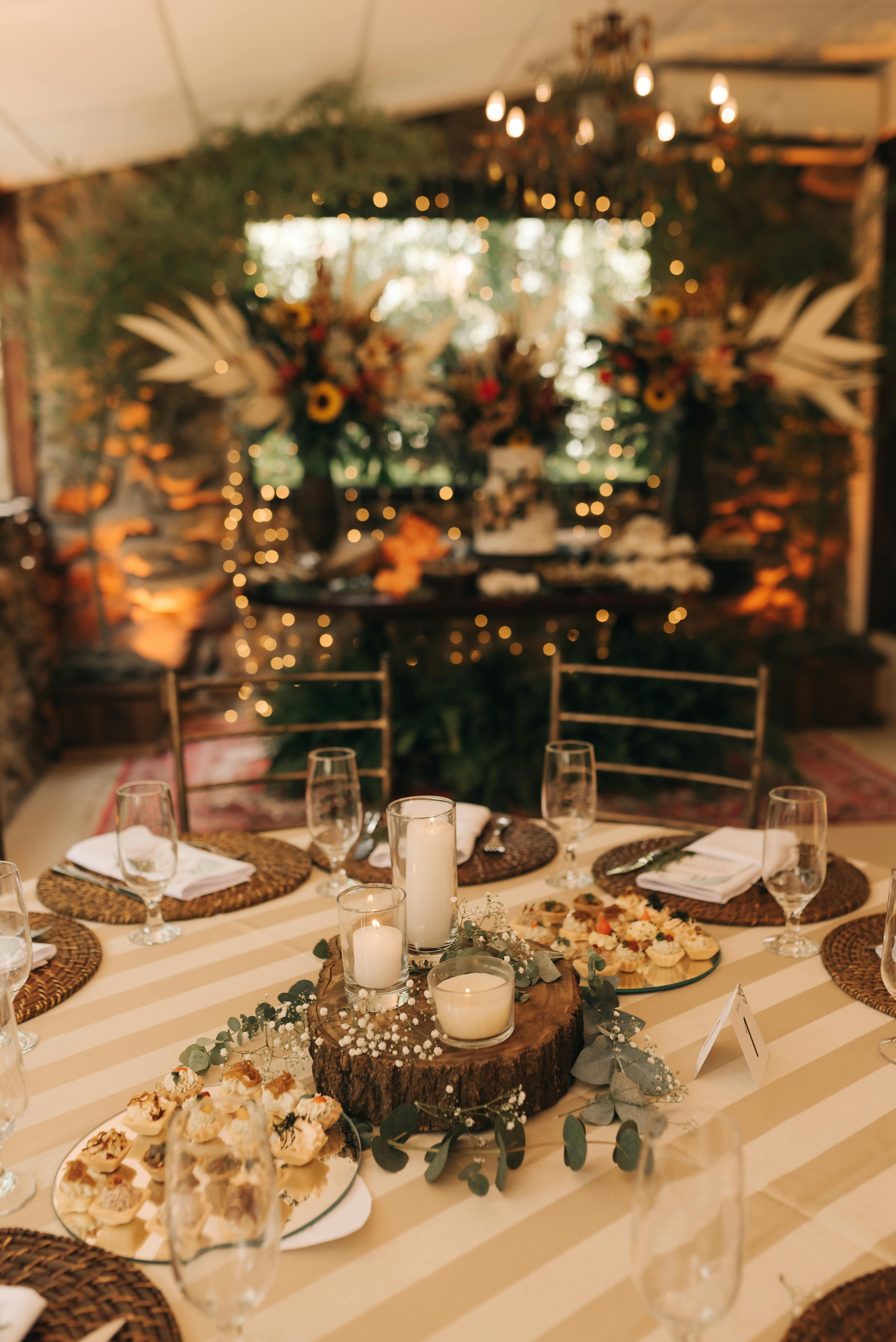 Charming rustic wedding reception setup with elegant table decor and ambient lighting.