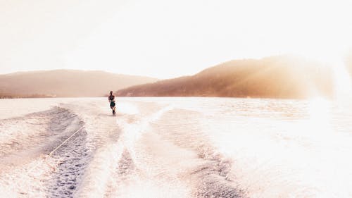 Free Person Wakeboarding on Lake Stock Photo